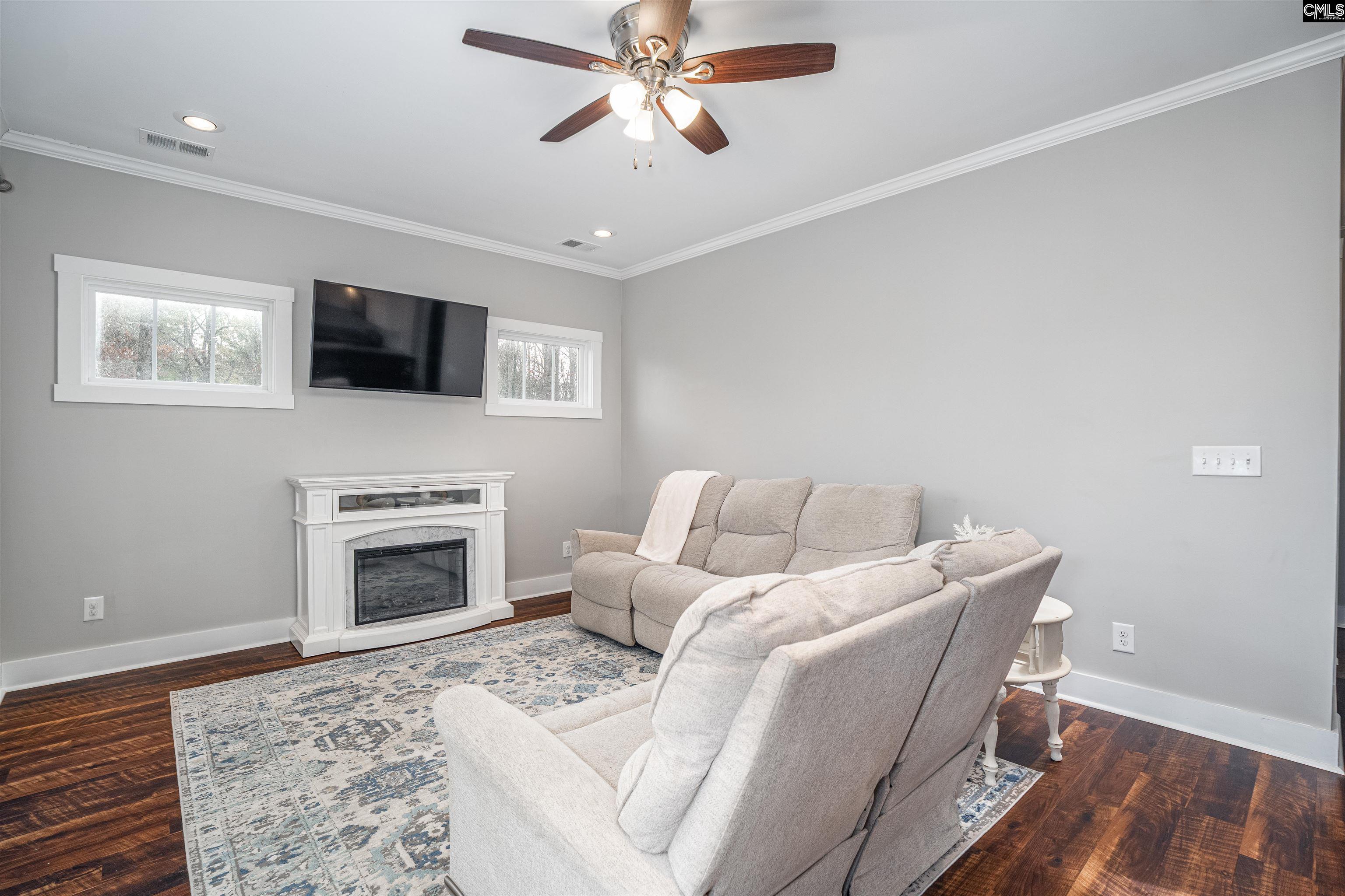 649 Sandbar Road Chapin, SC 29036 - Photo 7 of 40 a living room with furniture a flat screen tv and a fireplace