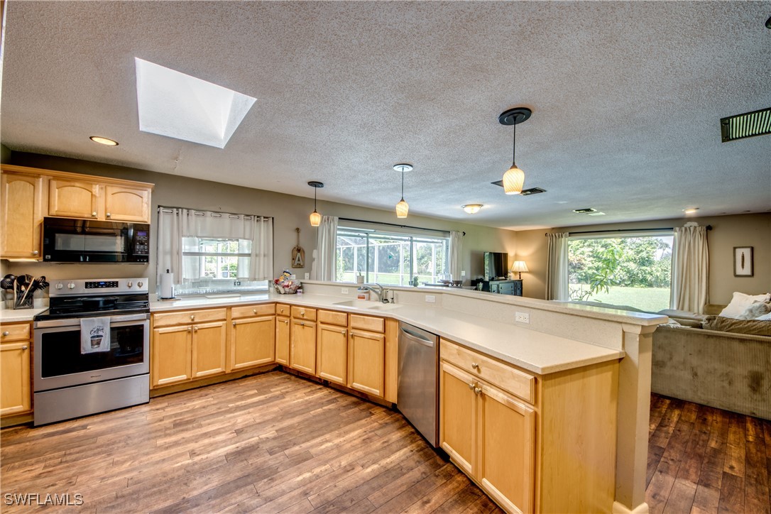 3651 Putter Point Lane Fort Myers, FL 33919 - Photo 11 of 33 a kitchen with stainless steel appliances granite countertop a sink and stove top oven