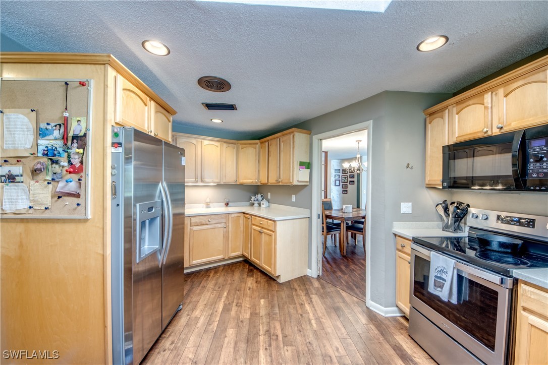 3651 Putter Point Lane Fort Myers, FL 33919 - Photo 12 of 33 a kitchen with a refrigerator and a stove top oven