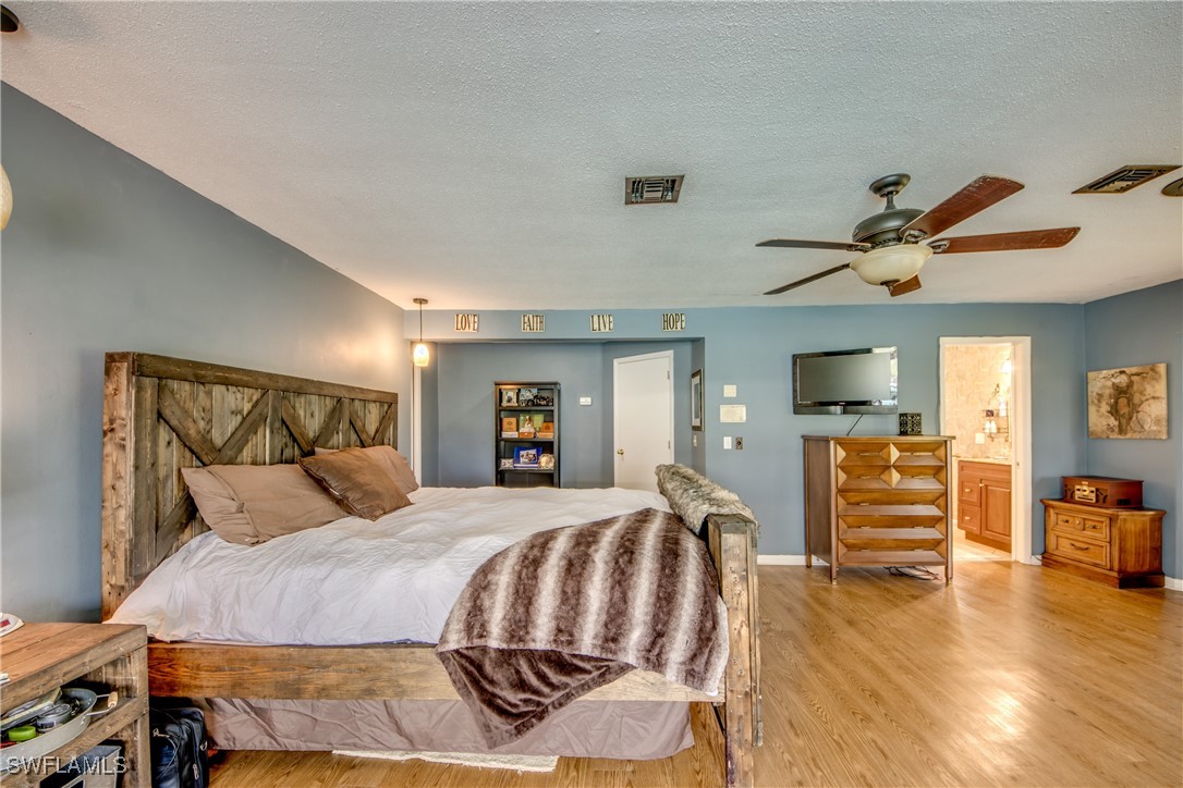 3651 Putter Point Lane Fort Myers, FL 33919 - Photo 18 of 33 a bedroom with a bed and wooden floor