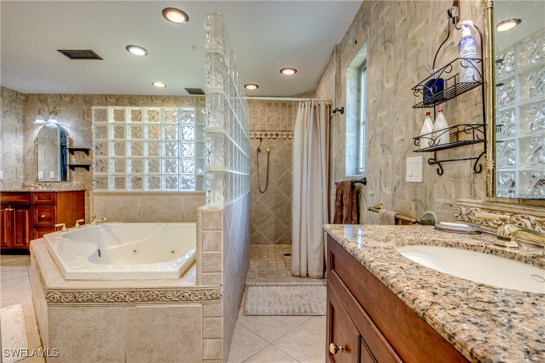 3651 Putter Point Lane Fort Myers, FL 33919 - Photo 20 of 33 a bathroom with a granite countertop sink and a bathtub