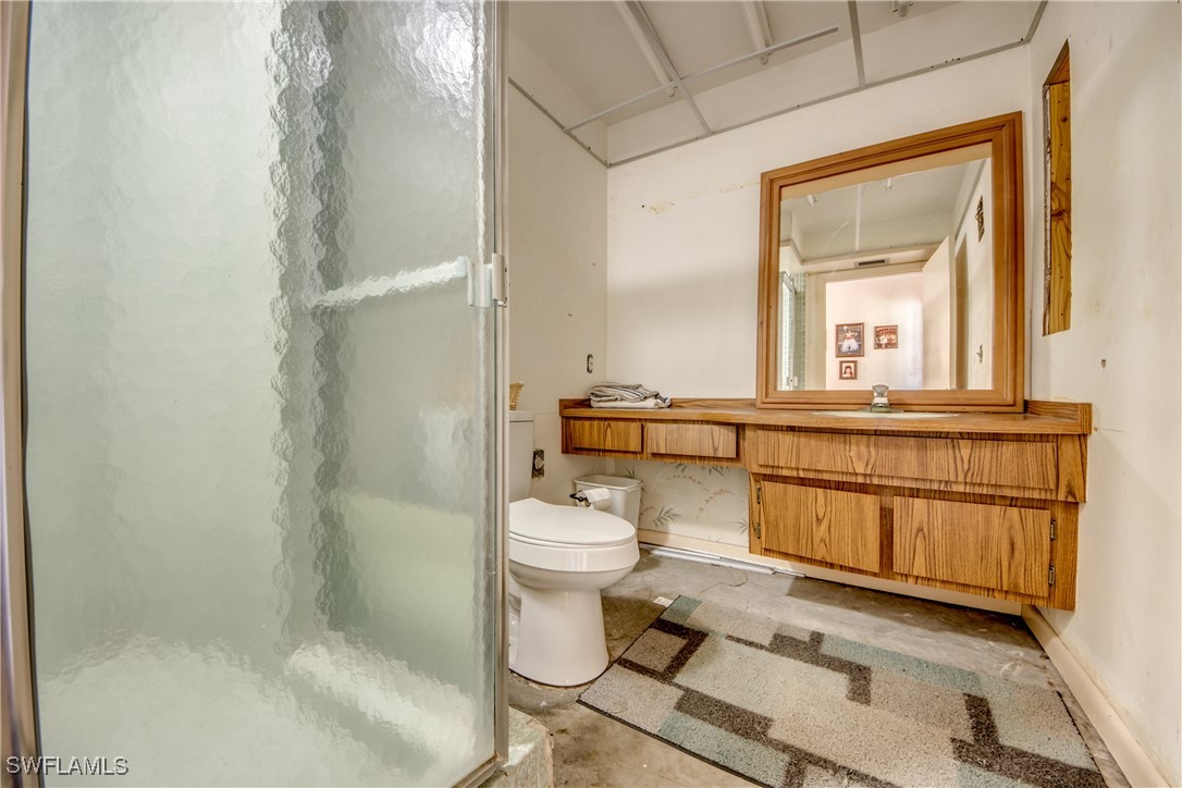 3651 Putter Point Lane Fort Myers, FL 33919 - Photo 25 of 33 a bathroom with a toilet a sink and a mirror