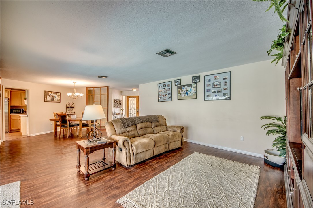 3651 Putter Point Lane Fort Myers, FL 33919 - Photo 7 of 33 a living room with furniture and a potted plant