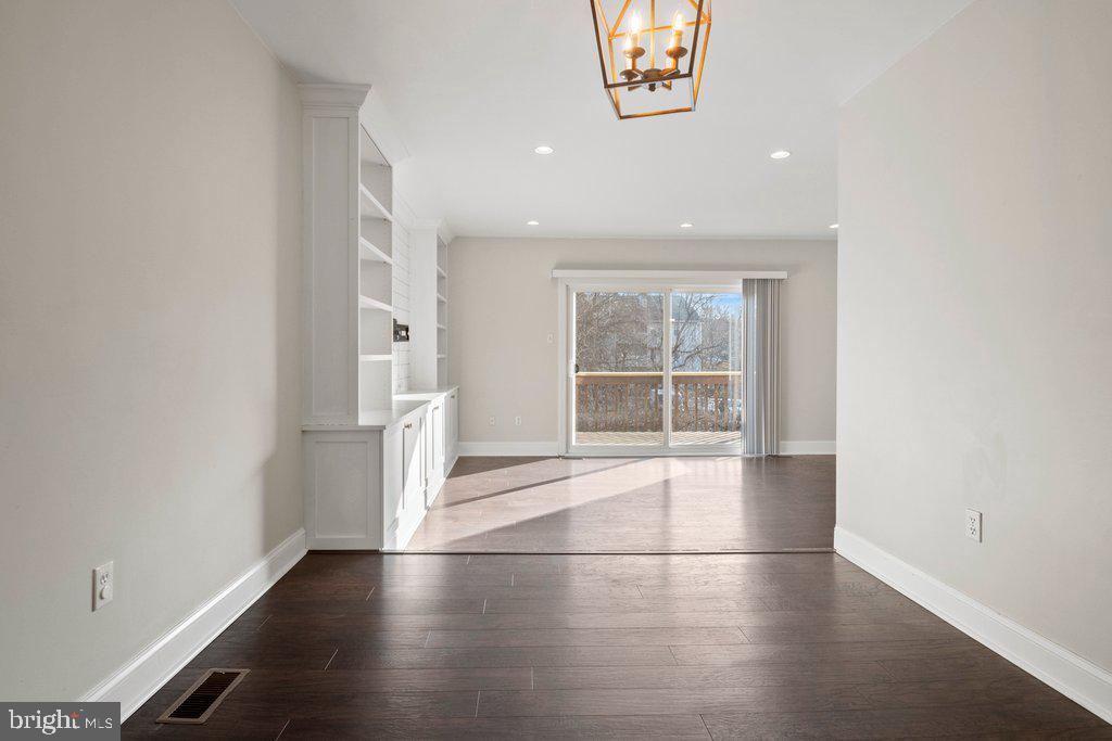 7472 Setting Sun Way Columbia, MD 21046 - Photo 16 of 40 an empty room with wooden floor and windows