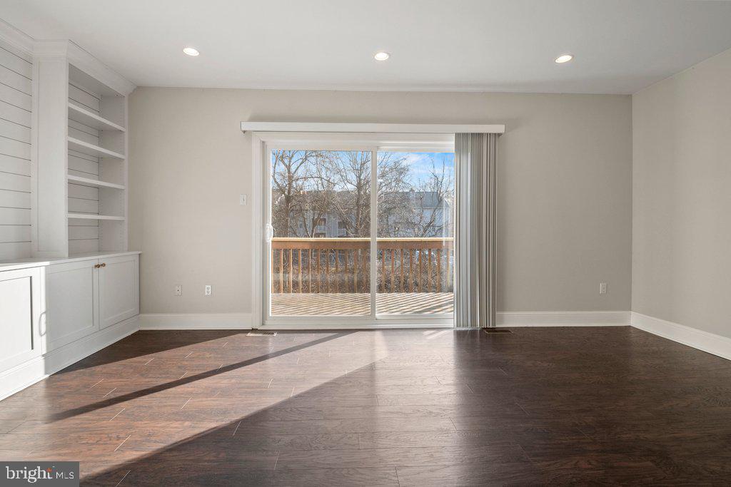 7472 Setting Sun Way Columbia, MD 21046 - Photo 18 of 40 a view of an empty room with wooden floor and a window