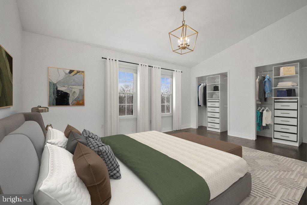 7472 Setting Sun Way Columbia, MD 21046 - Photo 22 of 40 a bedroom with a bed and a chandelier
