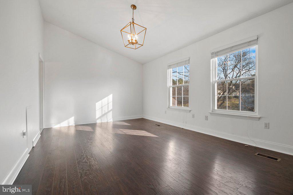 7472 Setting Sun Way Columbia, MD 21046 - Photo 23 of 40 a view of an empty room with wooden floor and a window