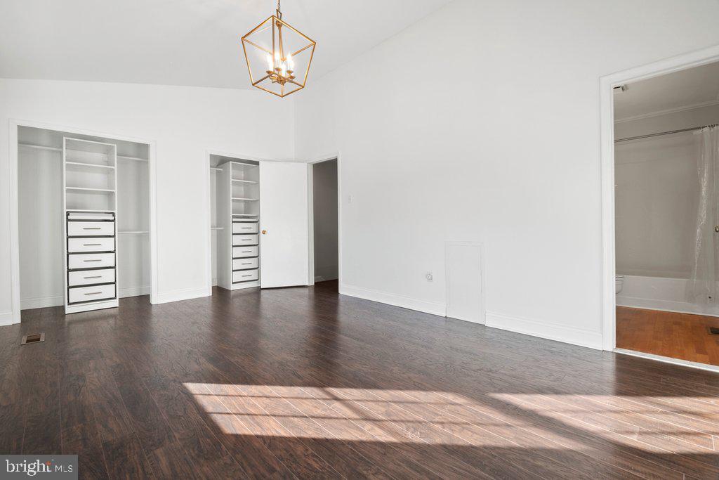 7472 Setting Sun Way Columbia, MD 21046 - Photo 25 of 40 an empty room with wooden floor cabinet and windows