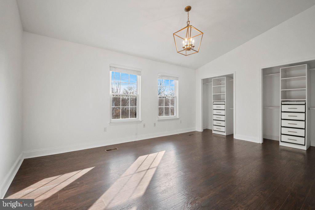 7472 Setting Sun Way Columbia, MD 21046 - Photo 26 of 40 a view of an empty room with a window and wooden floor