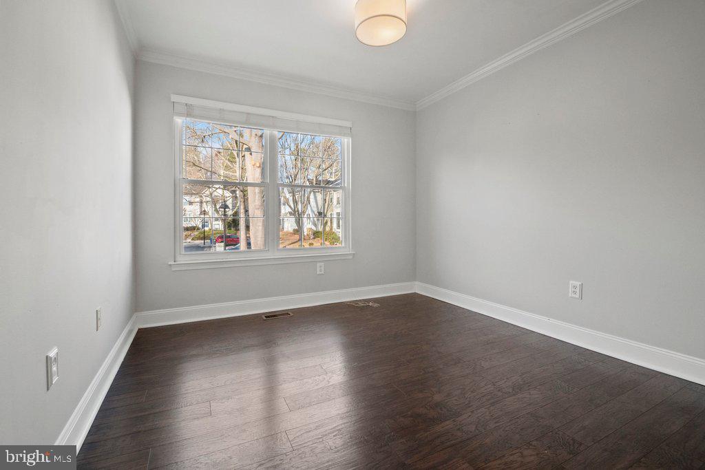 7472 Setting Sun Way Columbia, MD 21046 - Photo 28 of 40 an empty room with wooden floor and windows
