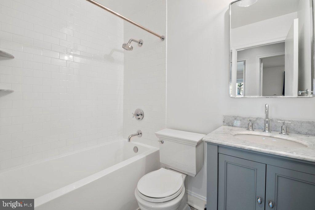 7472 Setting Sun Way Columbia, MD 21046 - Photo 30 of 40 a bathroom with a sink a toilet and shower
