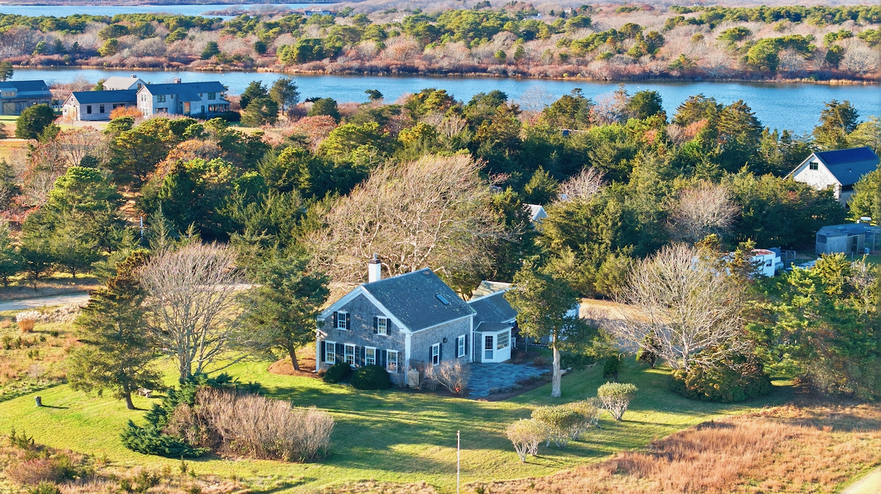 an aerial view of residential houses with outdoor space and swimming pool