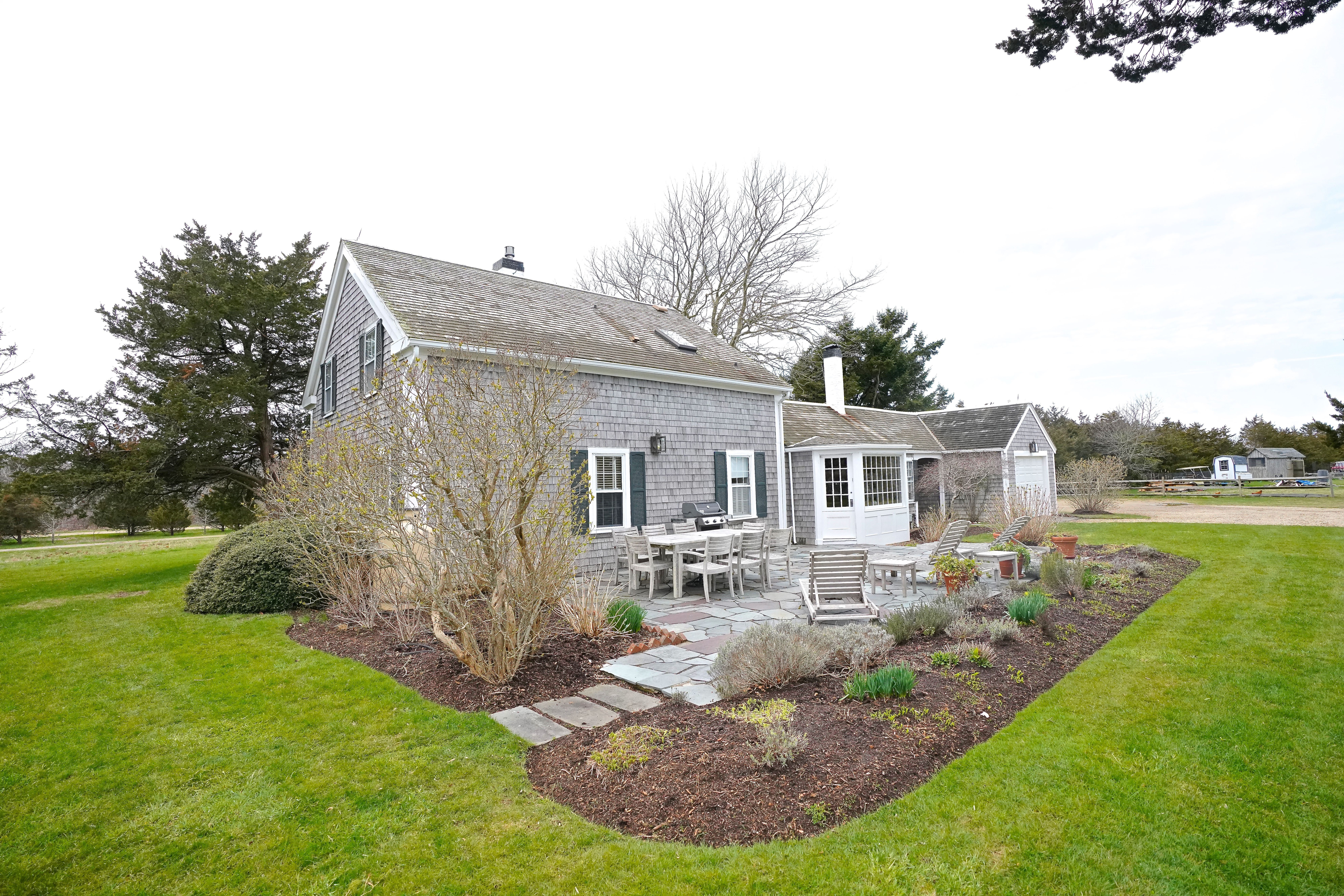 31 Butler's Cove Road Edgartown, MA 02539 - Photo 17 of 24 a view of a house with a backyard porch and sitting area