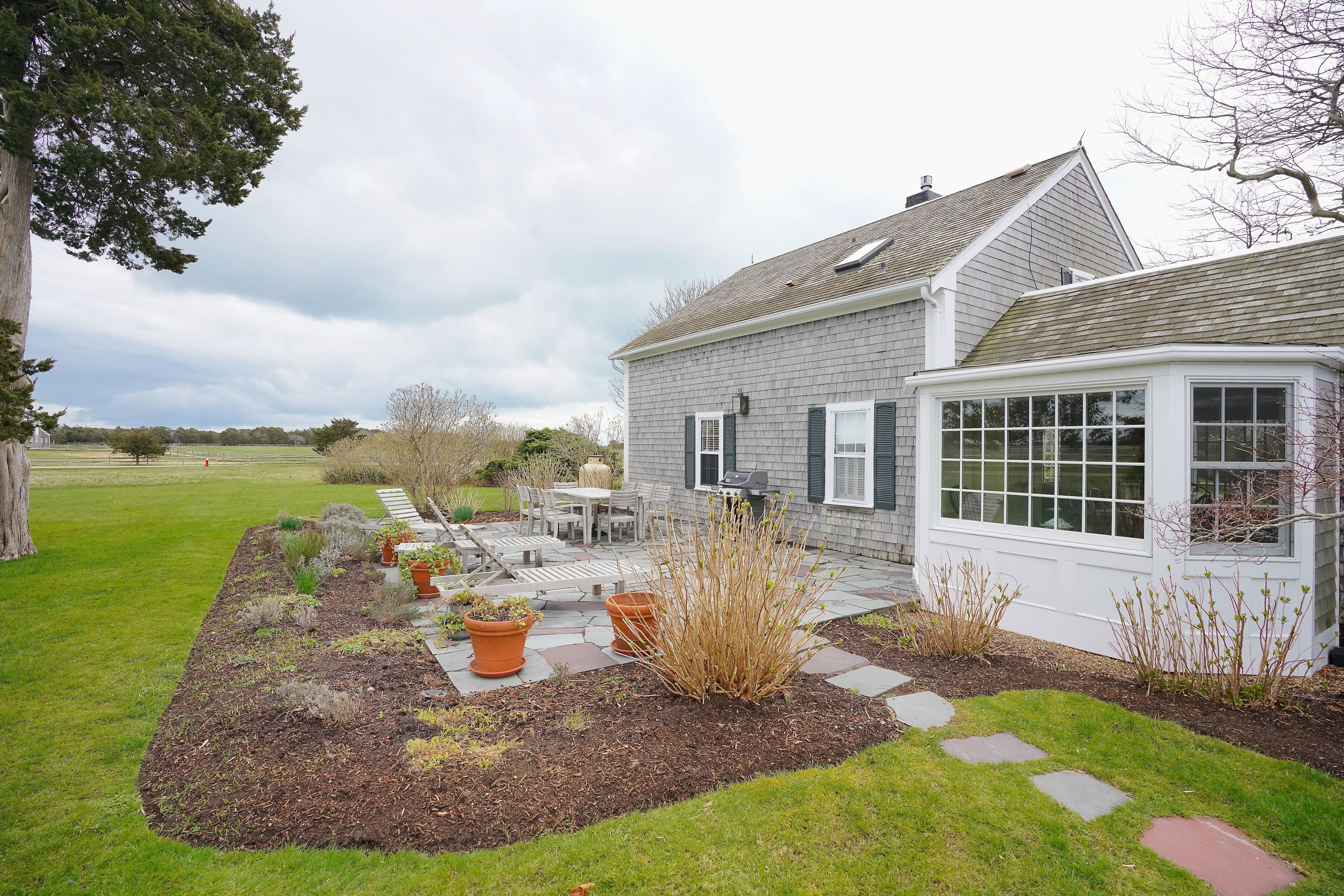 31 Butler's Cove Road Edgartown, MA 02539 - Photo 18 of 24 a view of a house with backyard sitting area and garden