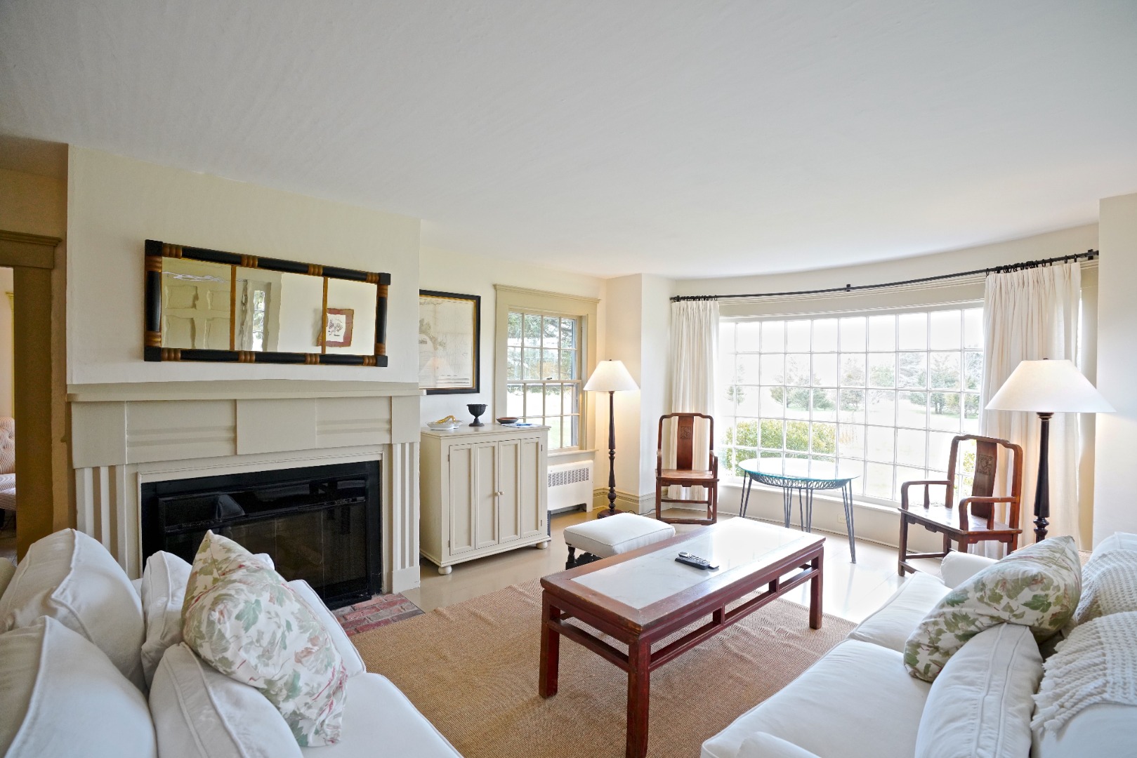 31 Butler's Cove Road Edgartown, MA 02539 - Photo 5 of 24 a living room with furniture a large window and a fireplace