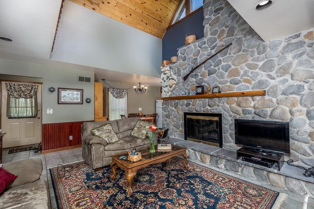 1985 North 3189th Road Ottawa, IL 61350 - Photo 13 of 30 a living room with furniture a flat screen tv and a fireplace