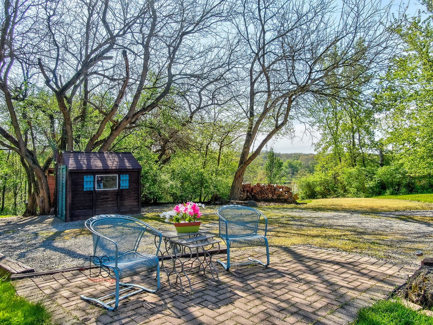 1985 North 3189th Road Ottawa, IL 61350 - Photo 24 of 30 a view of a patio with table and chairs potted plants and large tree