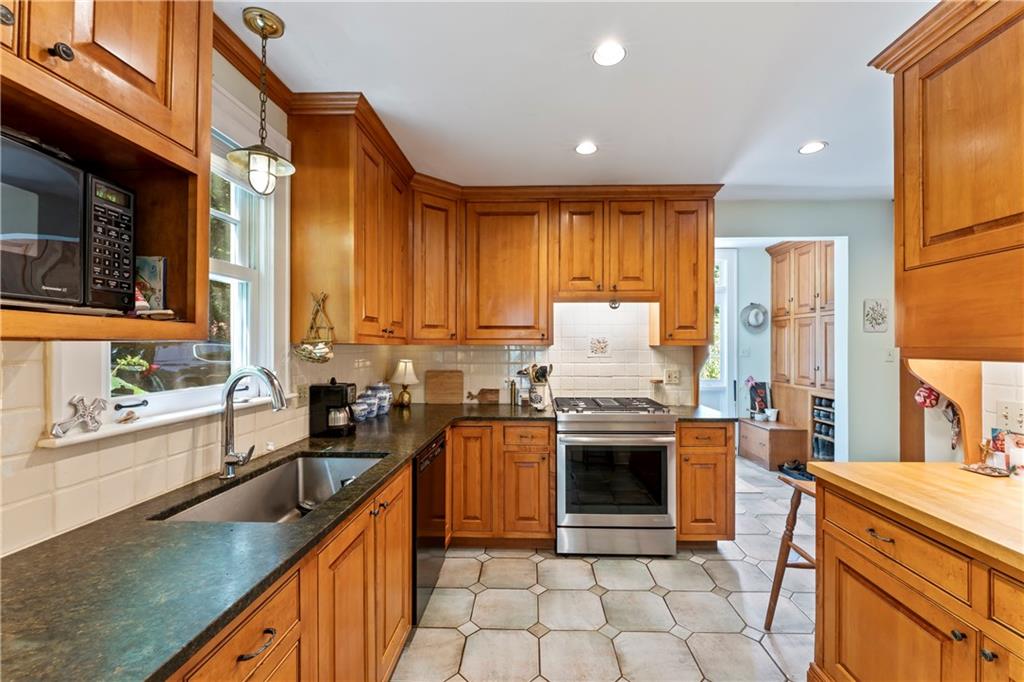 566 Dorseyville Road Pittsburgh, PA 15238 - Photo 11 of 48 a kitchen with stainless steel appliances granite countertop a stove a sink and a refrigerator