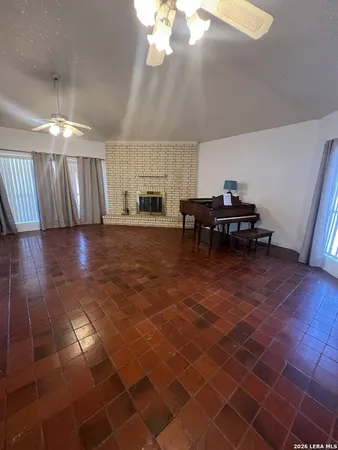 a view of a hall with a dining table and chairs