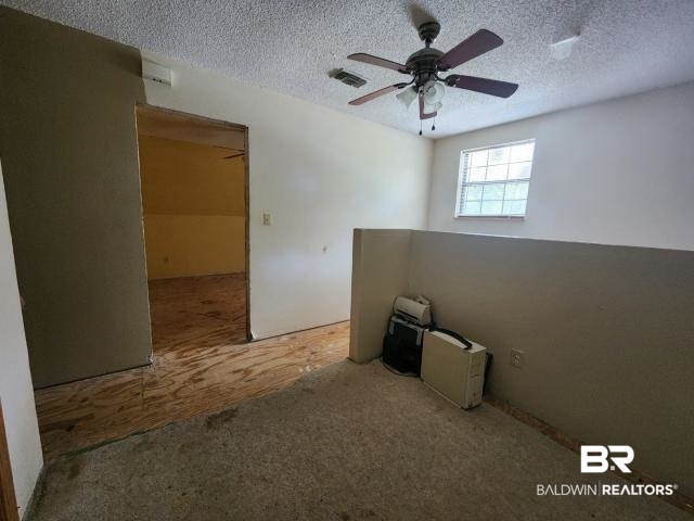 32749 Antietam Road Lillian, AL 36549 - Photo 24 of 47 Carpeted empty room with a textured ceiling and ceiling fan