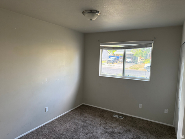 874 770 South Tooele, UT 84074 - Photo 10 of 19 Neutral toned walls with a single window featuring horizontal blinds