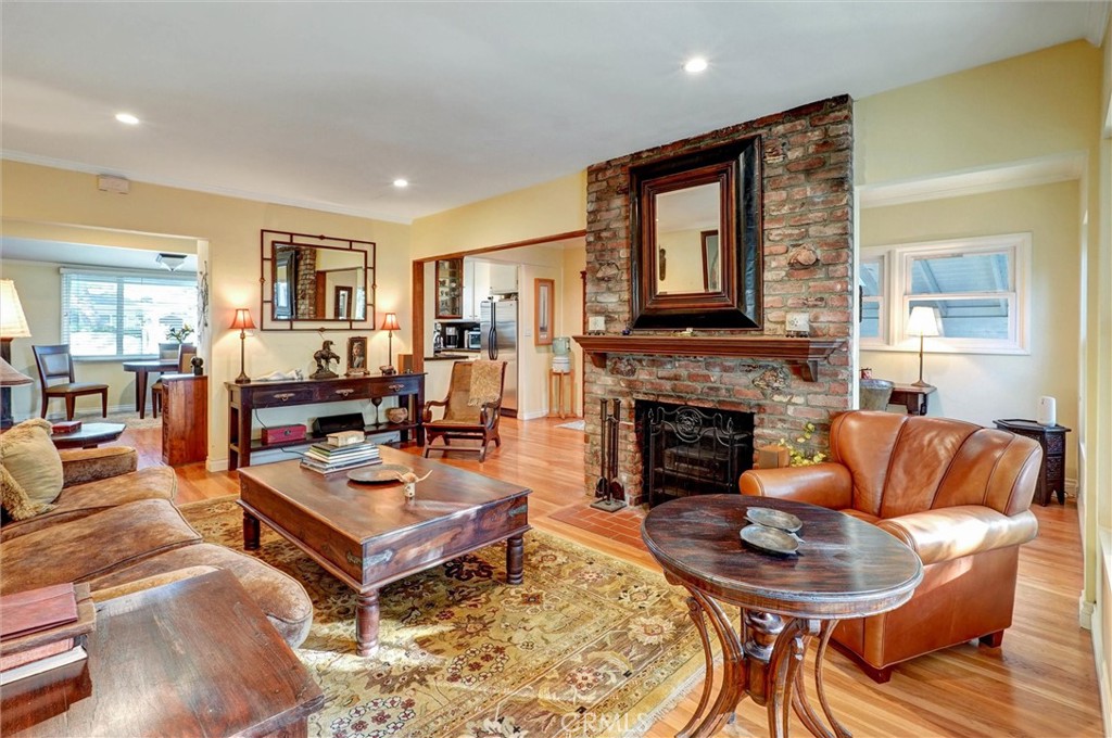 a living room with furniture a fireplace and a table