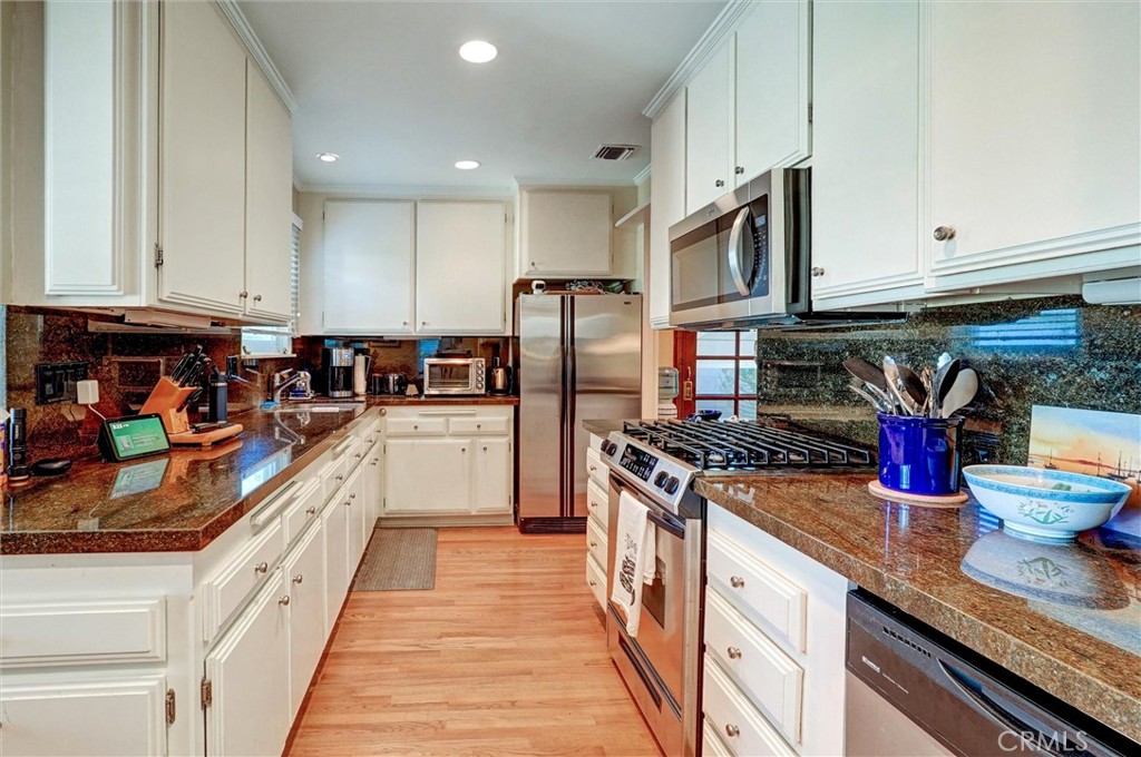 6649 Ranchito Avenue Van Nuys, CA 91405 - Photo 13 of 31 a kitchen with stainless steel appliances granite countertop a refrigerator a stove and a sink
