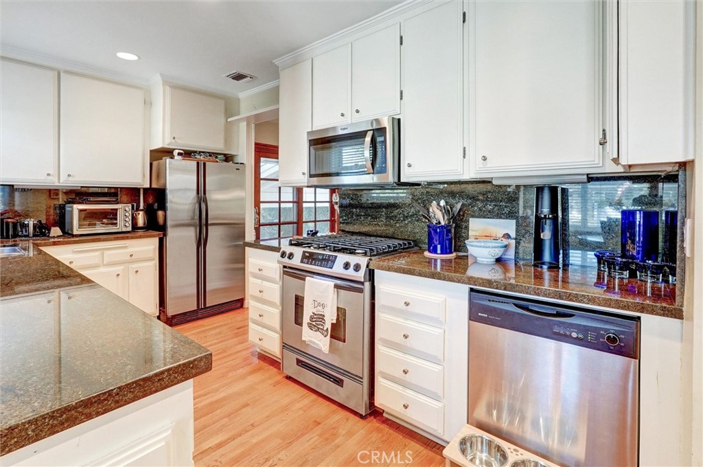 6649 Ranchito Avenue Van Nuys, CA 91405 - Photo 14 of 31 a kitchen with stainless steel appliances granite countertop a refrigerator and a stove top oven