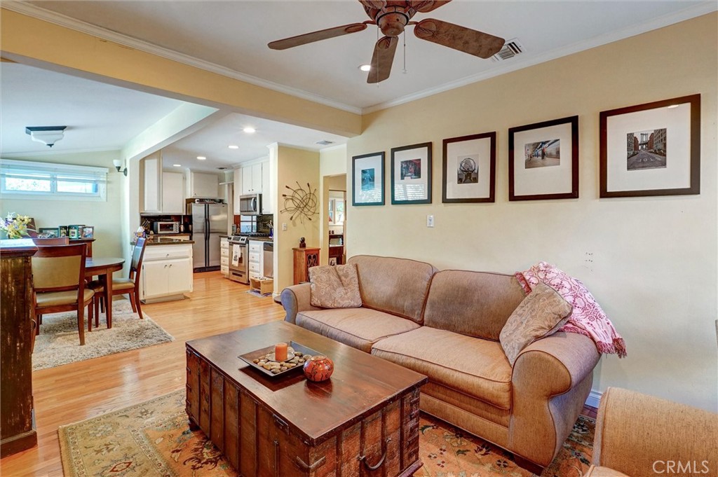 6649 Ranchito Avenue Van Nuys, CA 91405 - Photo 17 of 31 a living room with furniture kitchen view and a wooden floor