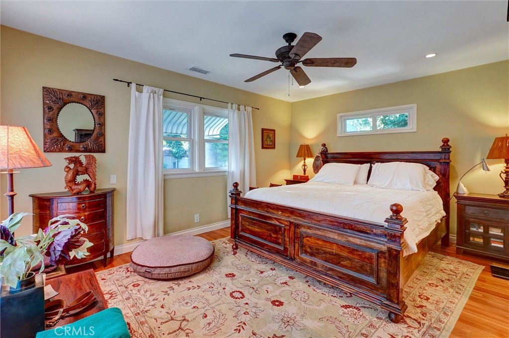 6649 Ranchito Avenue Van Nuys, CA 91405 - Photo 2 of 31 a bedroom with a bed and dresser with wooden floor
