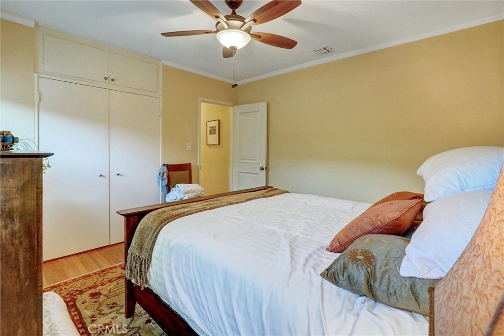 6649 Ranchito Avenue Van Nuys, CA 91405 - Photo 22 of 31 a bedroom with a bed and a chandelier