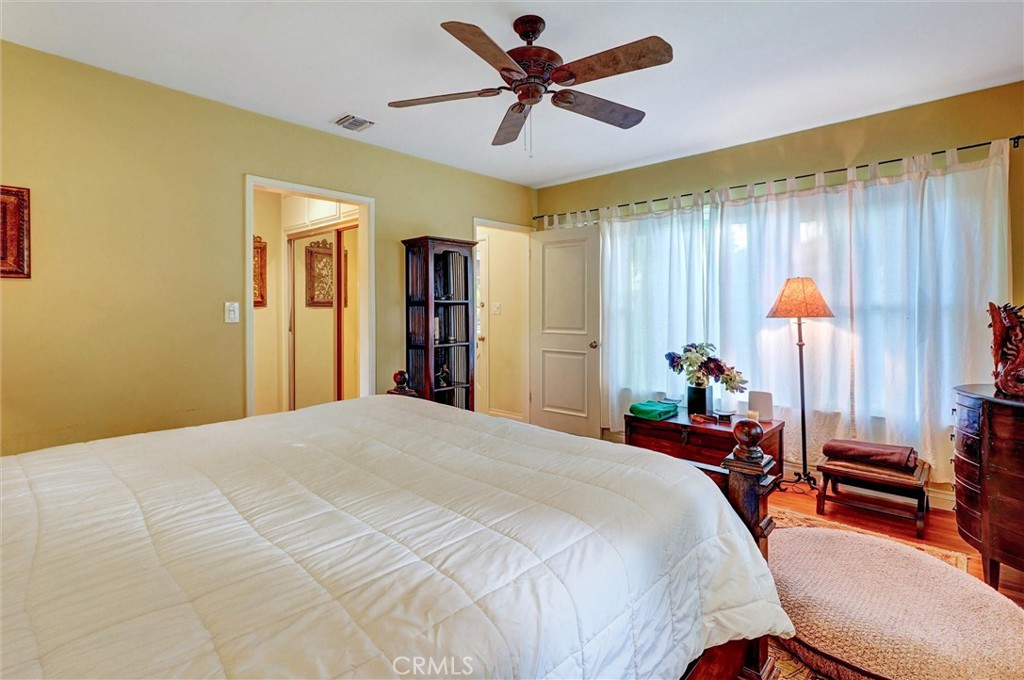 6649 Ranchito Avenue Van Nuys, CA 91405 - Photo 10 of 31 a bedroom with a bed and a chandelier