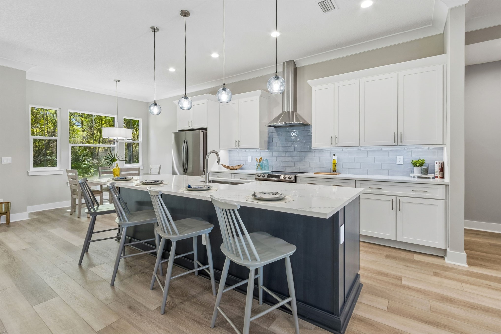 96050 Captains Pointe Road Yulee, FL 32097 - Photo 13 of 36 a kitchen with a dining table chairs sink and cabinets