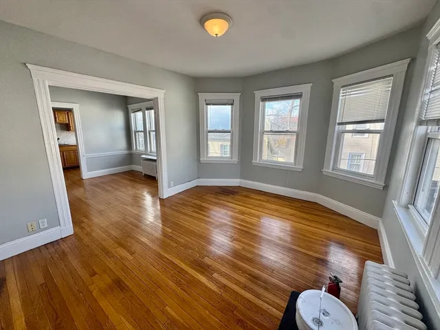 wooden floor in an empty room with a window and wooden floor
