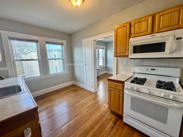a kitchen with a stove oven and cabinets