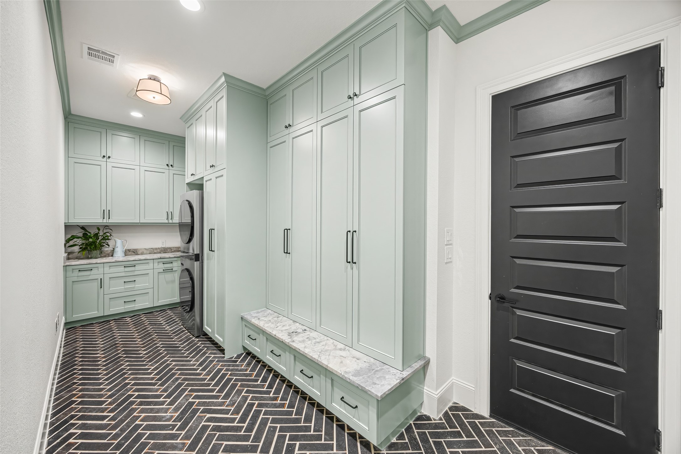 19314 Chateau Ridge Court Tomball, TX 77377 - Photo 36 of 50 Downstairs laundry room with generous custom cabinetry and elegant designer finishes throughout.