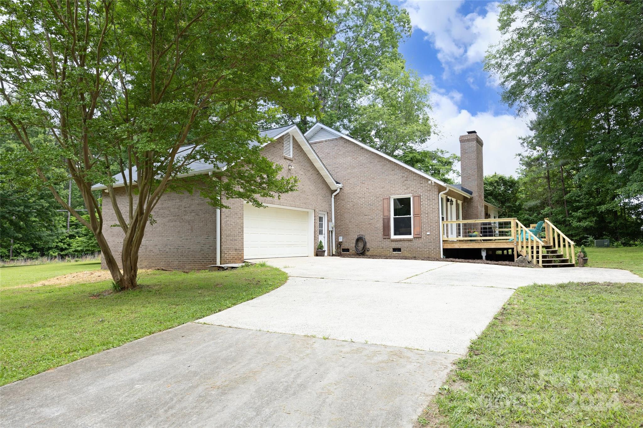 819 Homestead Road Chapel Hill, NC 27516 - Photo 11 of 42 a front view of a house with a yard and garage