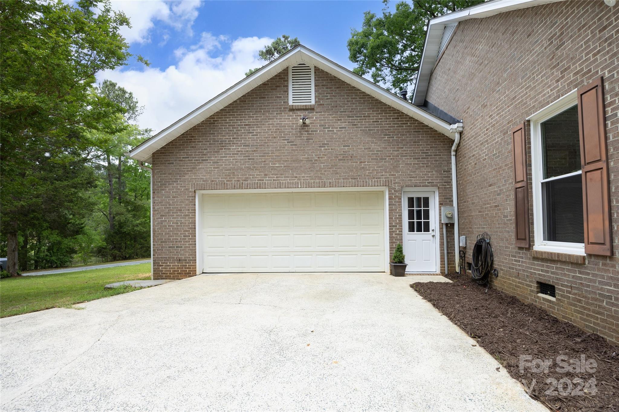 819 Homestead Road Chapel Hill, NC 27516 - Photo 13 of 42 a front view of a house with a yard and garage