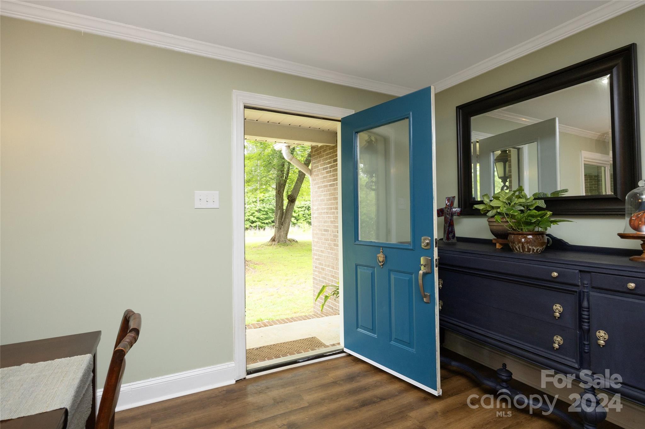 819 Homestead Road Chapel Hill, NC 27516 - Photo 17 of 42 a view of a hallway with furniture and wooden floor
