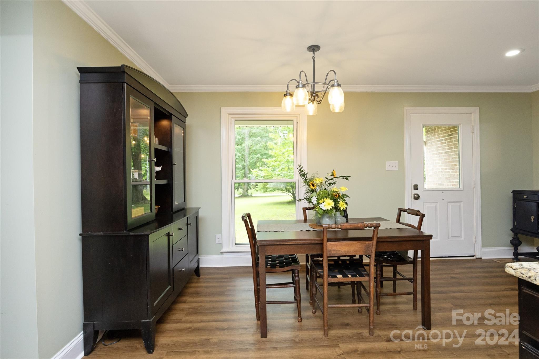 819 Homestead Road Chapel Hill, NC 27516 - Photo 19 of 42 a view of a dining room with furniture window and wooden floor