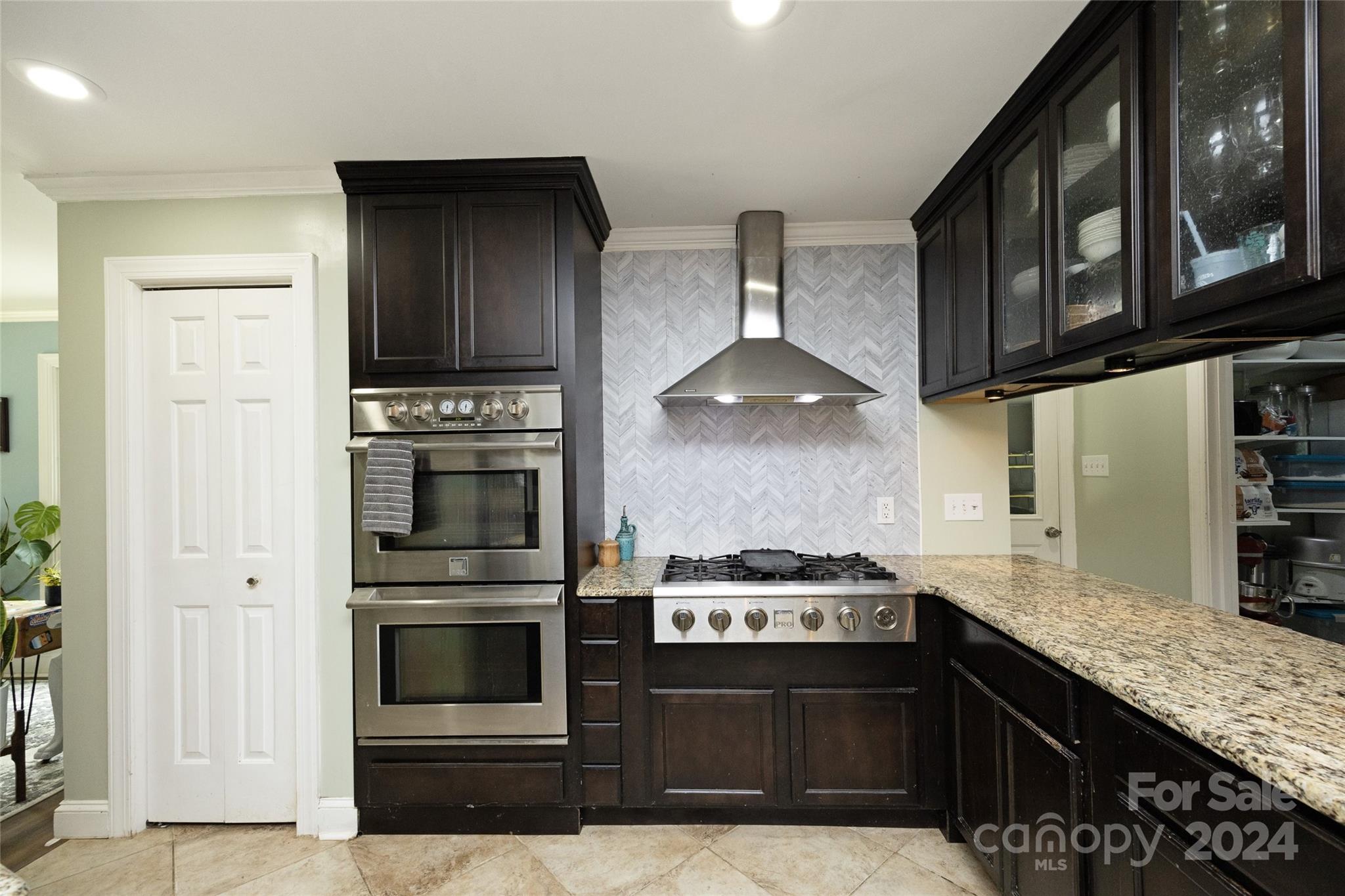 819 Homestead Road Chapel Hill, NC 27516 - Photo 22 of 42 a kitchen with stainless steel appliances granite countertop a stove and a microwave