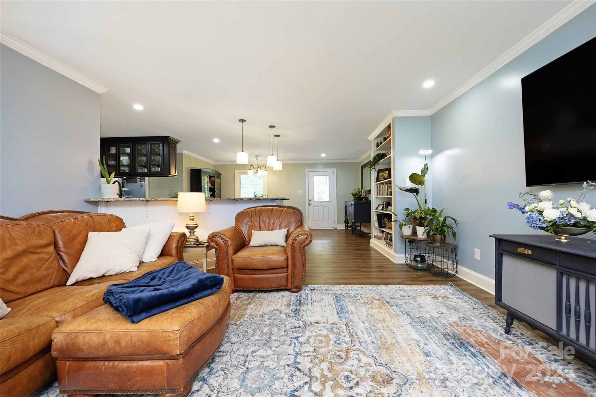 819 Homestead Road Chapel Hill, NC 27516 - Photo 25 of 42 a living room with furniture and a flat screen tv
