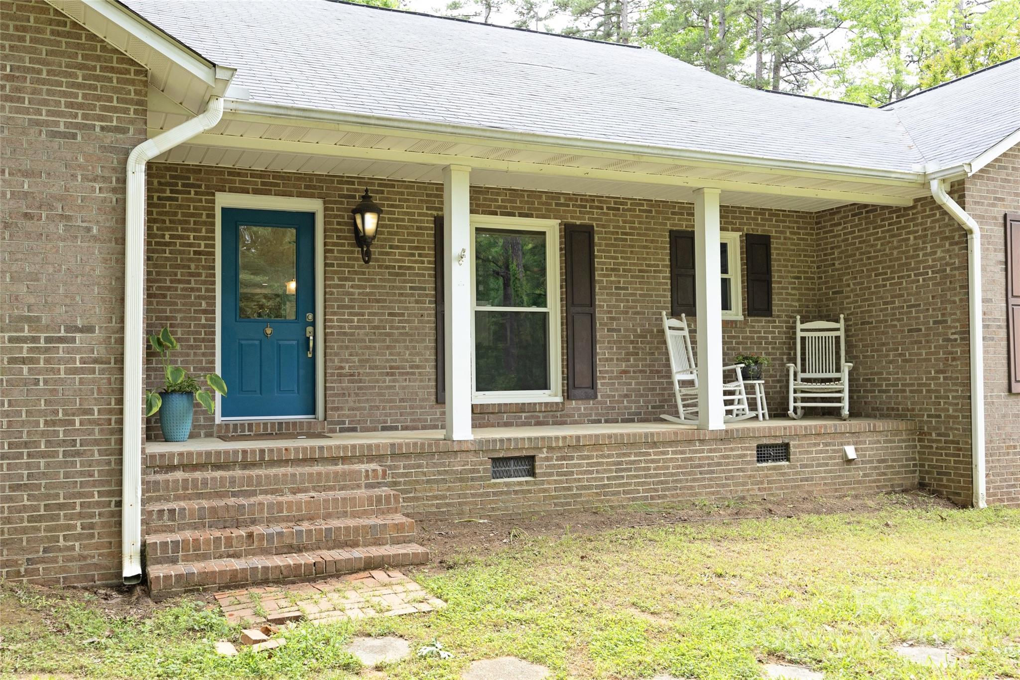819 Homestead Road Chapel Hill, NC 27516 - Photo 3 of 42 a view of a brick house with many windows