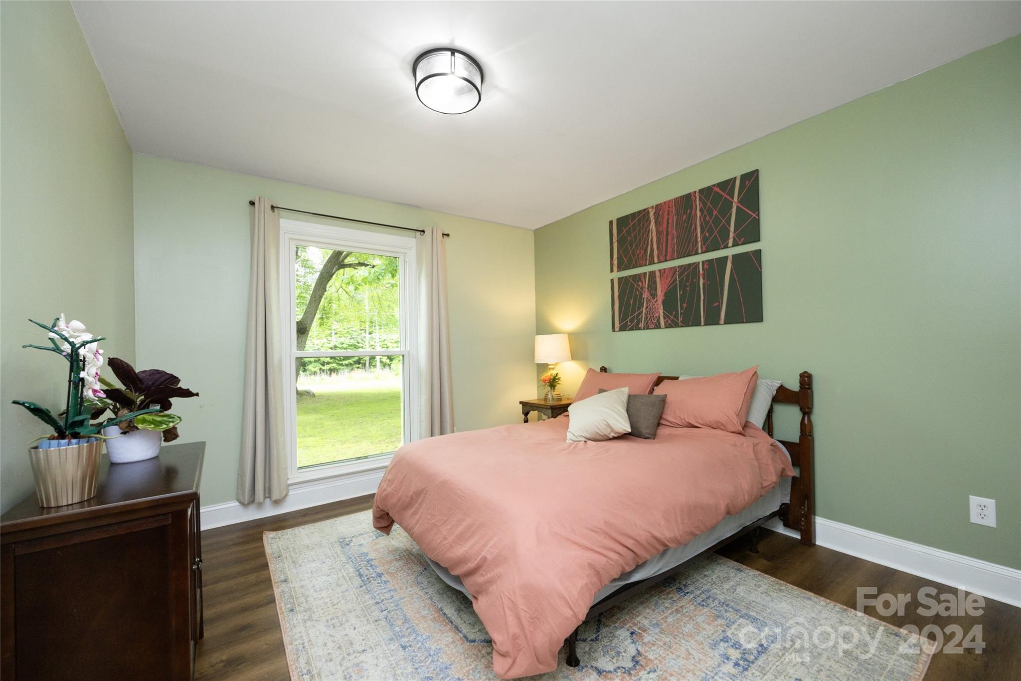 819 Homestead Road Chapel Hill, NC 27516 - Photo 34 of 42 a bedroom with a bed flat screen tv and window