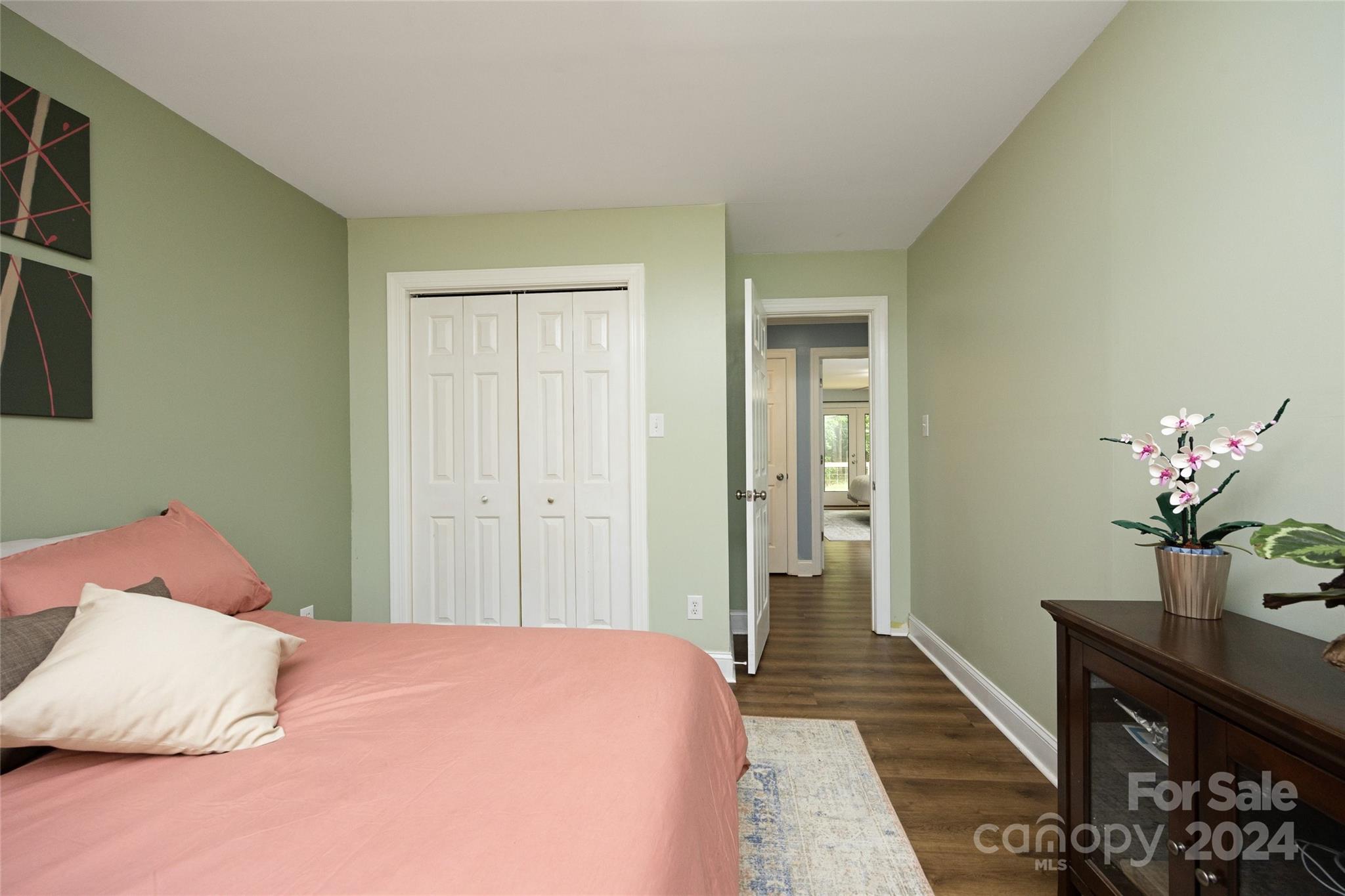 819 Homestead Road Chapel Hill, NC 27516 - Photo 35 of 42 a bedroom with a bed and a potted plant