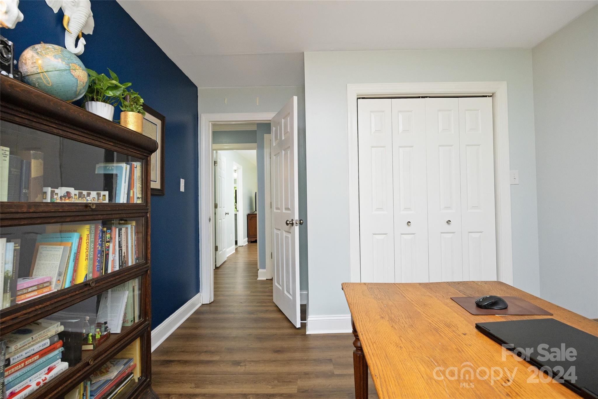 819 Homestead Road Chapel Hill, NC 27516 - Photo 37 of 42 a view of a hallway to room with wooden floor and cabinets