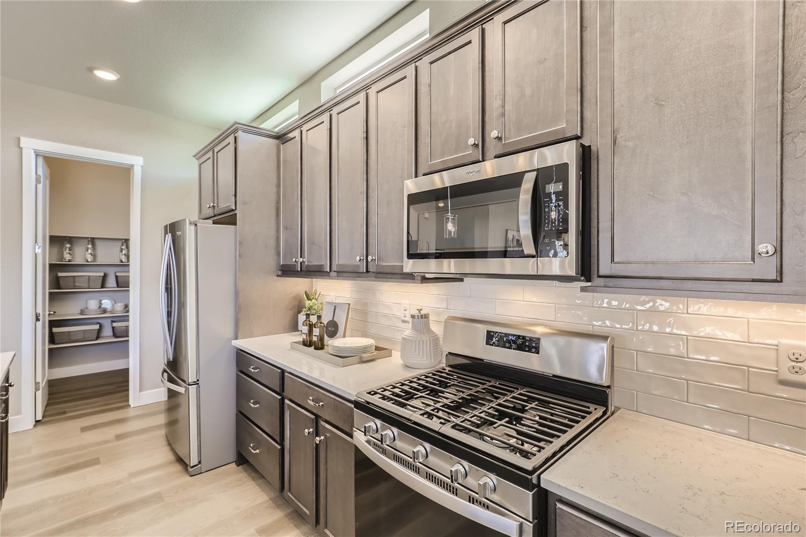 Undisclosed Address Denver, CO 80238 - Photo 13 of 21 a kitchen with stainless steel appliances granite countertop a stove a sink and a microwave