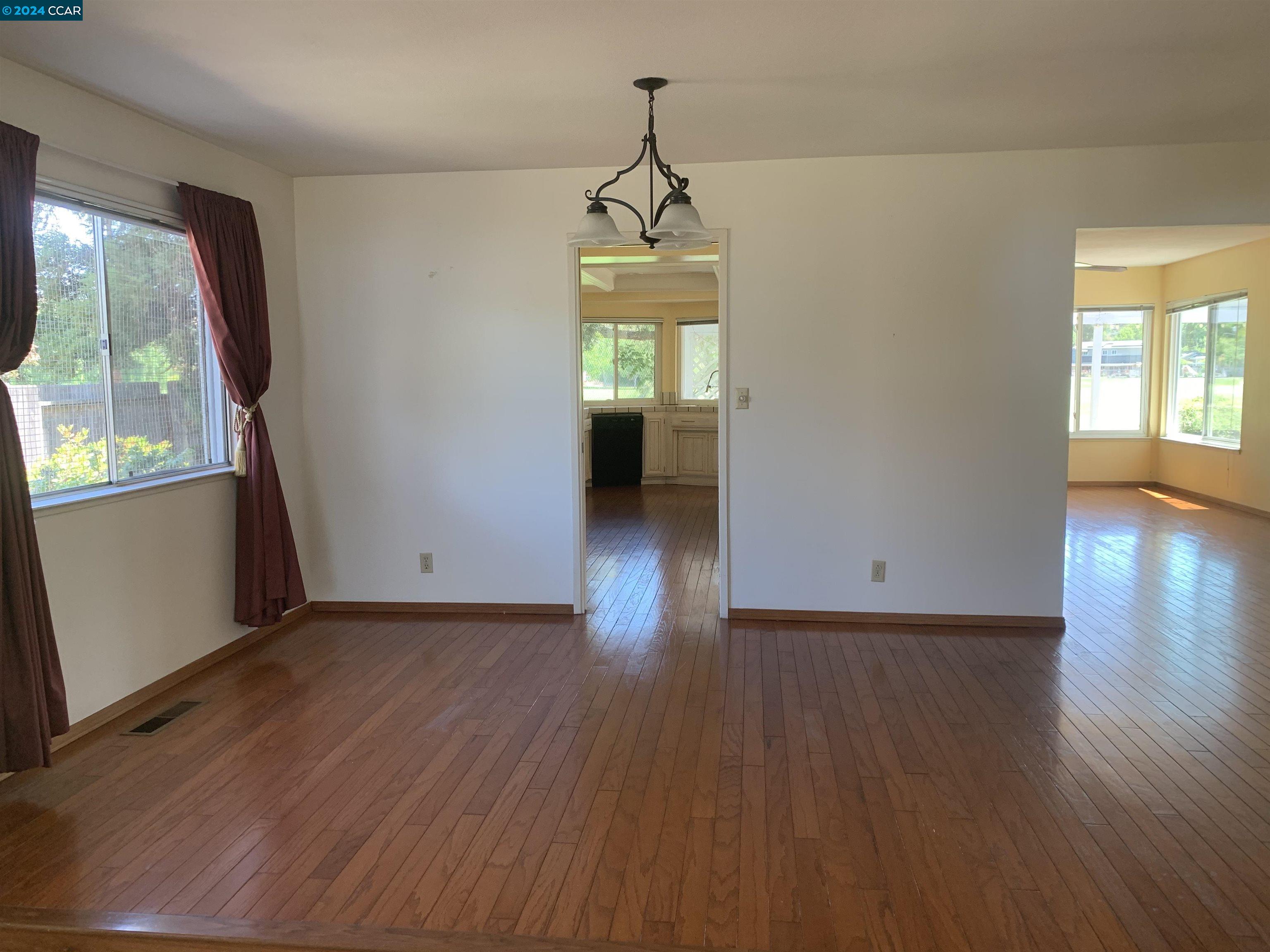 9462 Thunderbird Place San Ramon, CA 94583 - Photo 12 of 17 an empty room with wooden floor and windows