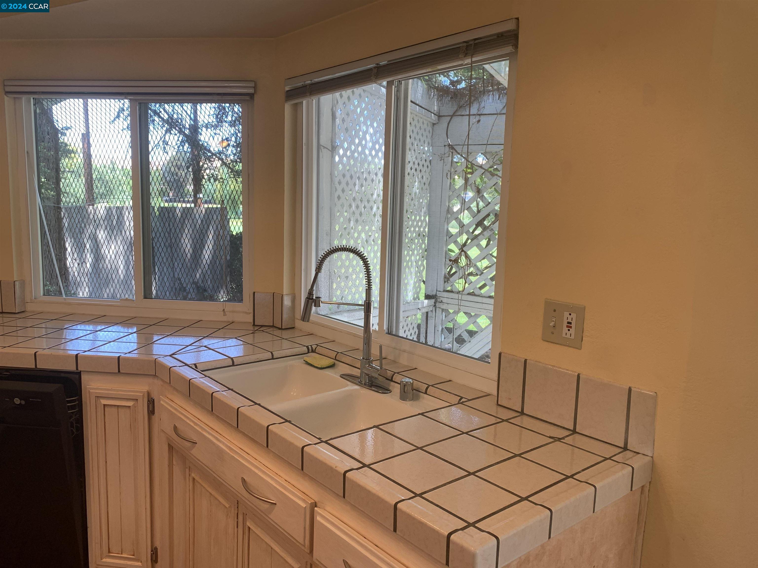 9462 Thunderbird Place San Ramon, CA 94583 - Photo 16 of 17 a kitchen with a sink and a stove top oven