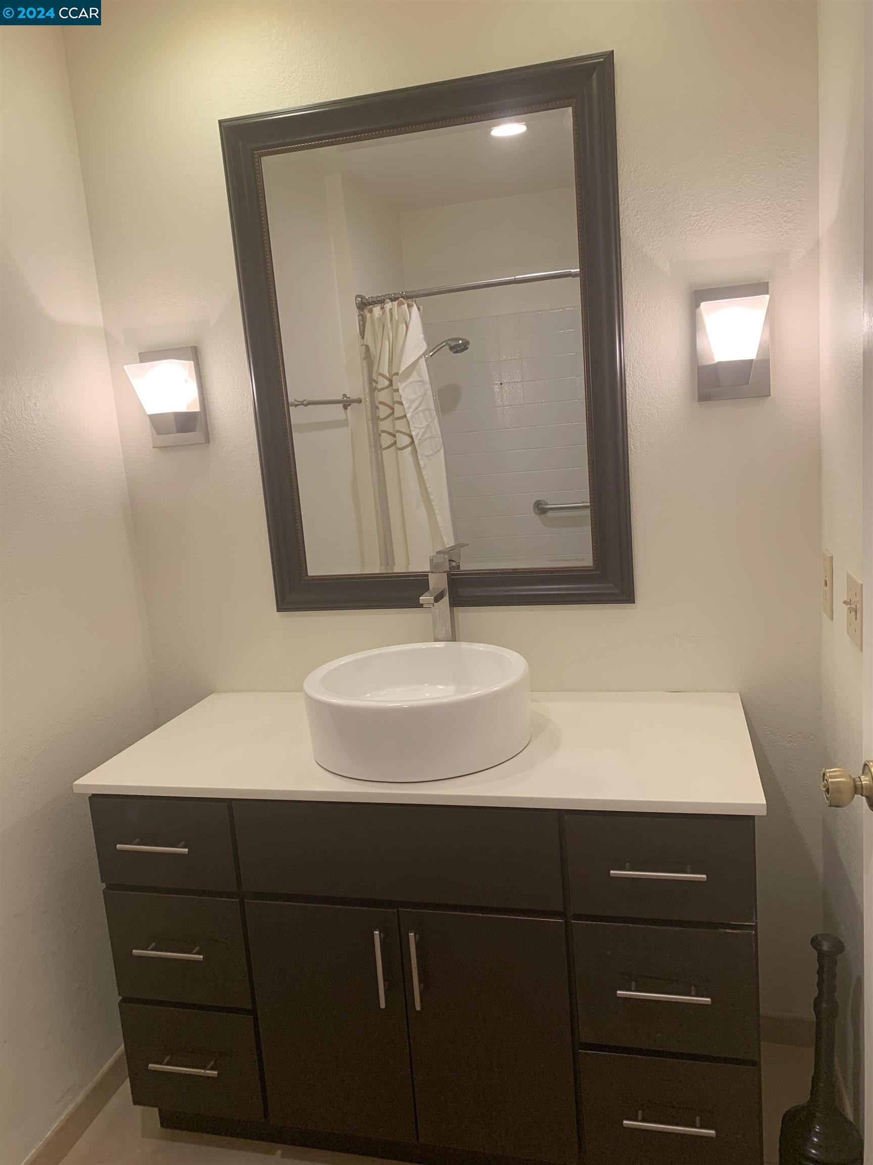 9462 Thunderbird Place San Ramon, CA 94583 - Photo 6 of 17 a bathroom with a sink and a mirror